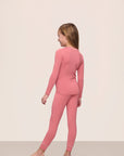 Model wearing Kids TENCEL™ Modal Unisex Long PJ Set in Sunkissed Coral/Ivory