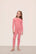 Model wearing Kids TENCEL™ Modal Unisex Long PJ Set in Sunkissed Coral/Ivory