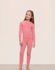 Model wearing Kids TENCEL™ Modal Unisex Long PJ Set in Sunkissed Coral/Ivory