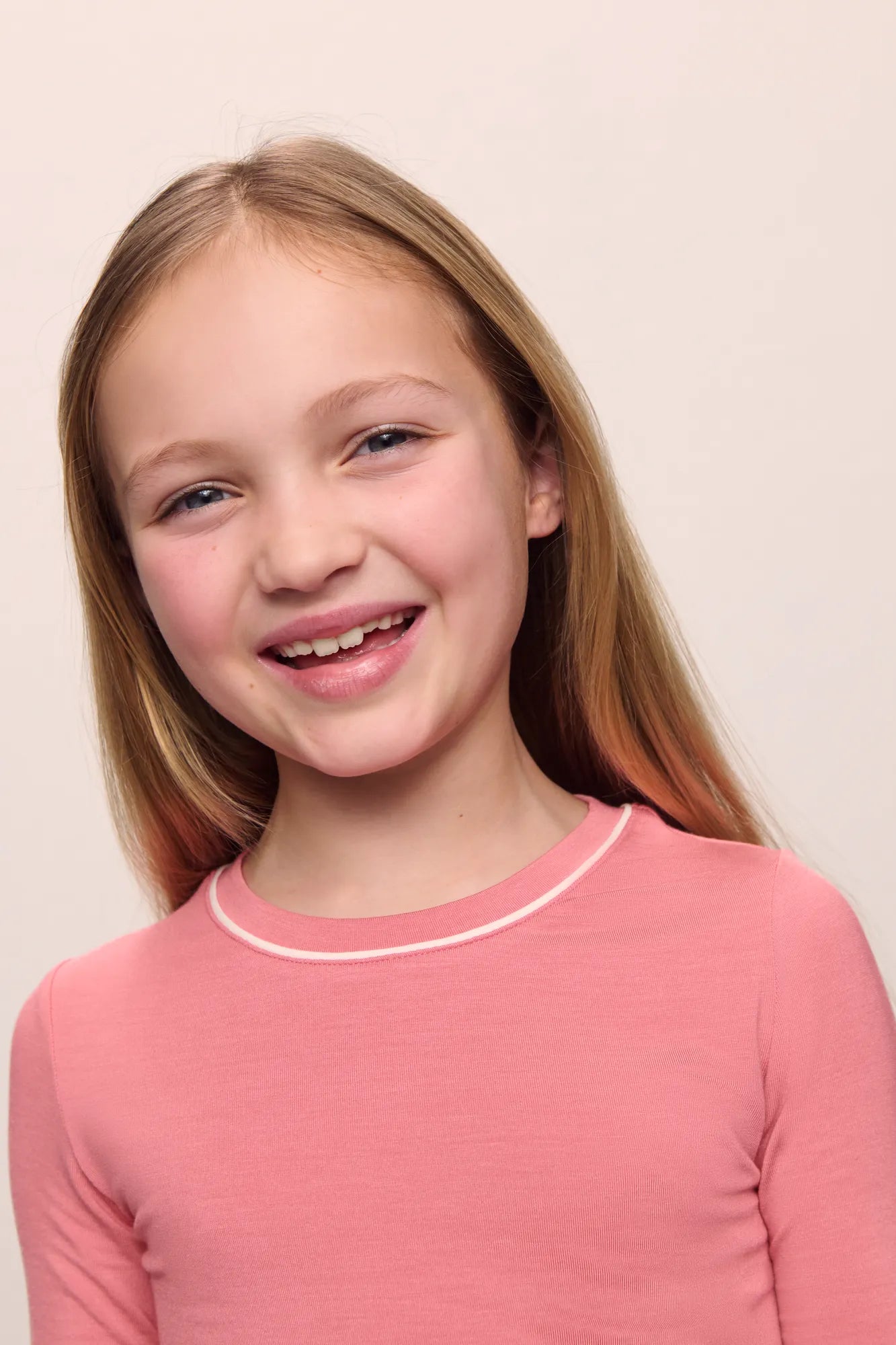 Model wearing Kids TENCEL™ Modal Unisex Long PJ Set in Sunkissed Coral/Ivory