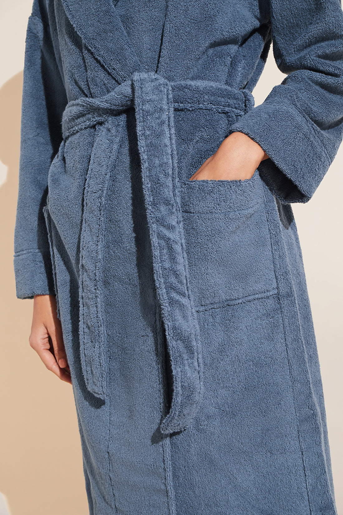 Model wears Terry Gender Neutral Robe in Coastal Blue.