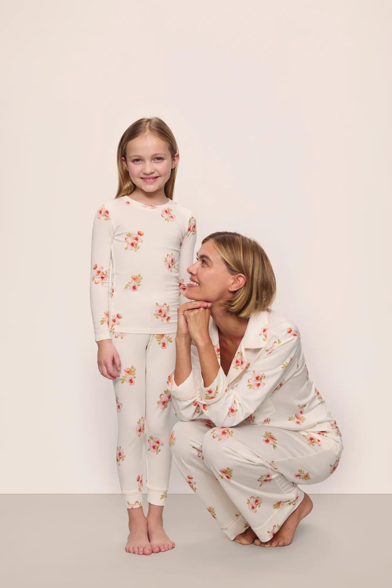 Model is wearing Kids Printed TENCEL™ Modal Unisex Long PJ Set in  Floral Bloom Ivy/Vanilla Cream with adult model in matching Gisele Printed TENCEL™ Modal Long PJ Set 