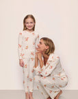 Model is wearing Kids Printed TENCEL™ Modal Unisex Long PJ Set in Floral Bloom Ivy/Vanilla Cream with adult model in matching Gisele Printed TENCEL™ Modal Long PJ Set