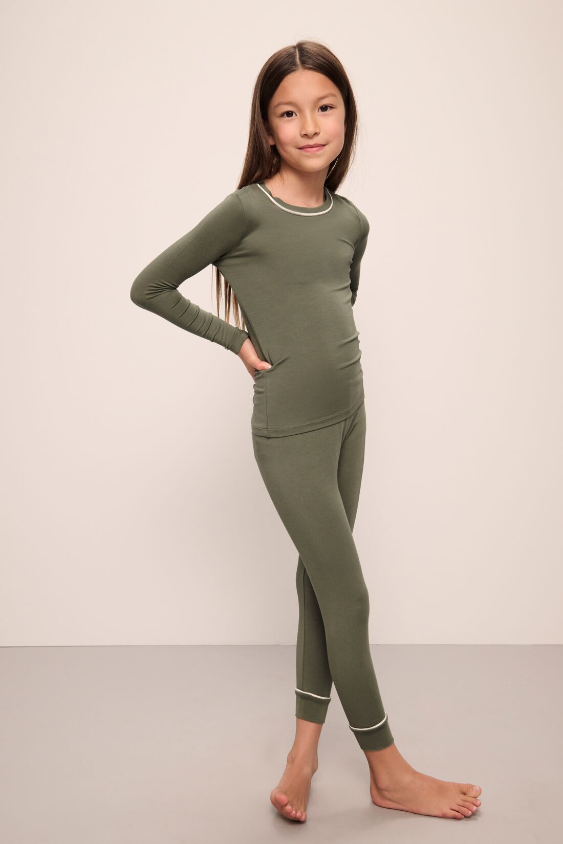 Model wears Kids TENCEL™ Modal Unisex Long PJ Set in moss/ivory.