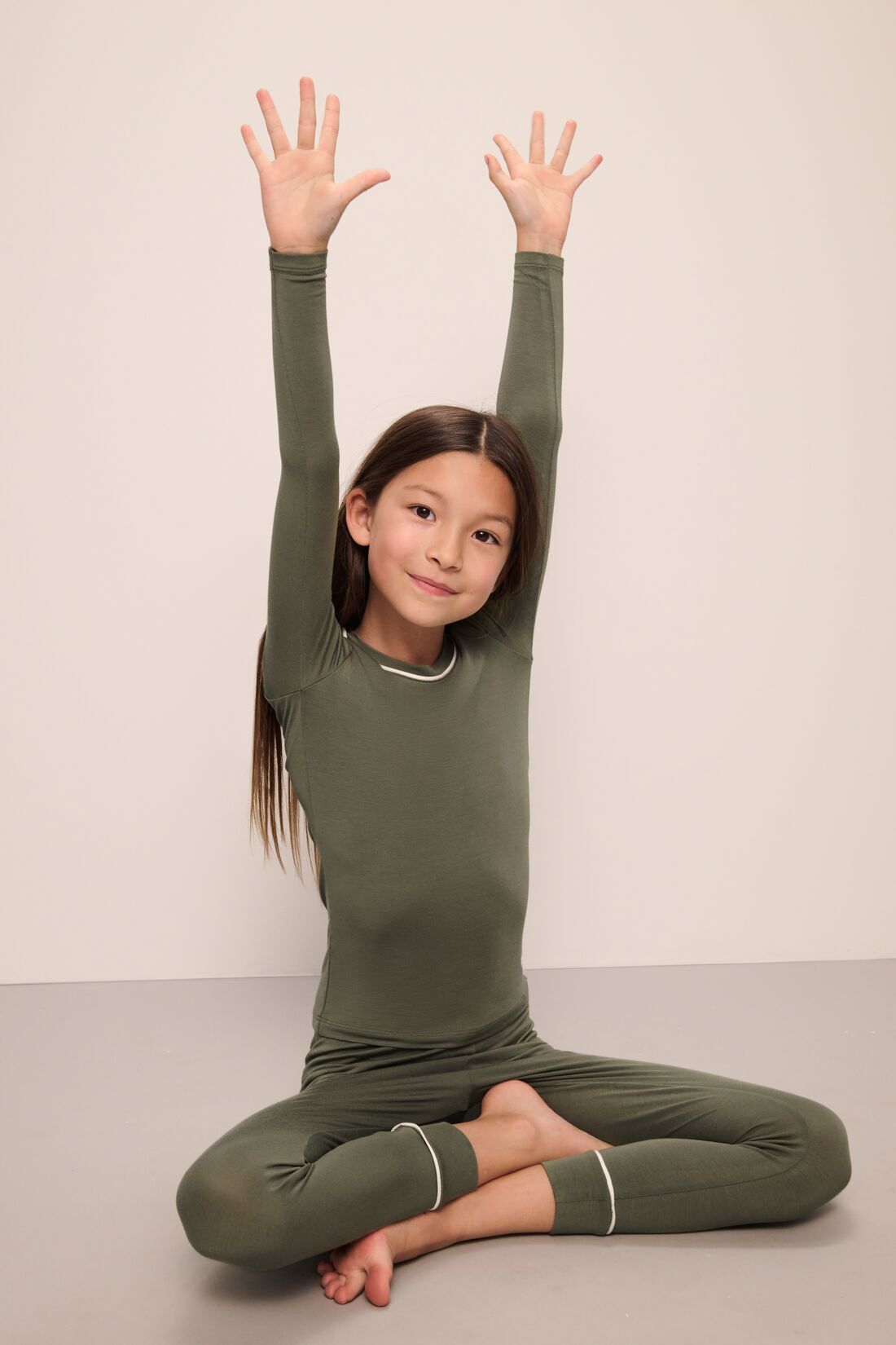 Model wears Kids TENCEL™ Modal Unisex Long PJ Set in moss/ivory.