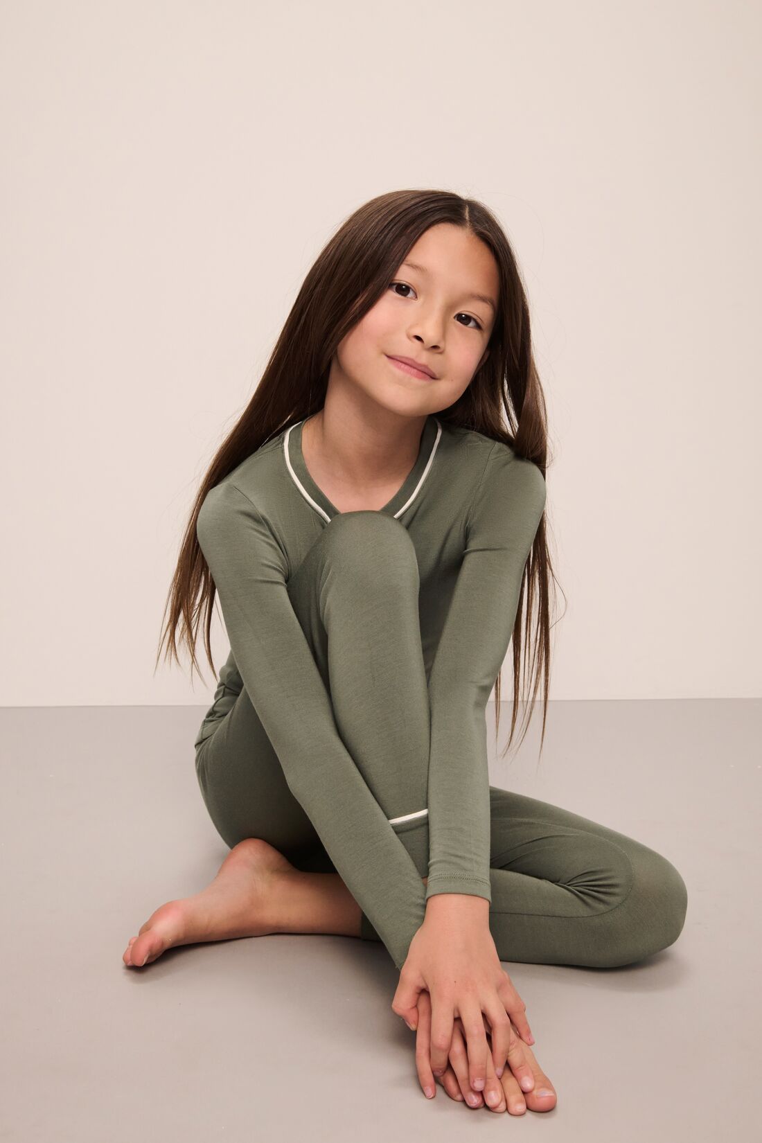 Model wears Kids TENCEL™ Modal Unisex Long PJ Set in moss/ivory.