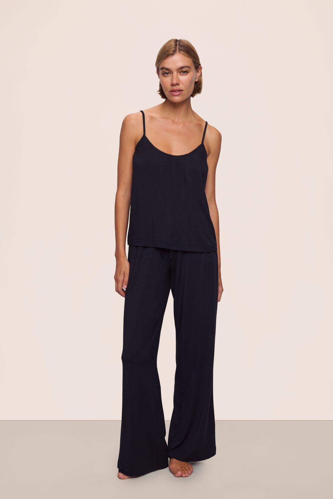 Model is wearing Gisele TENCEL™ Modal Cami & Pant PJ Set in Black