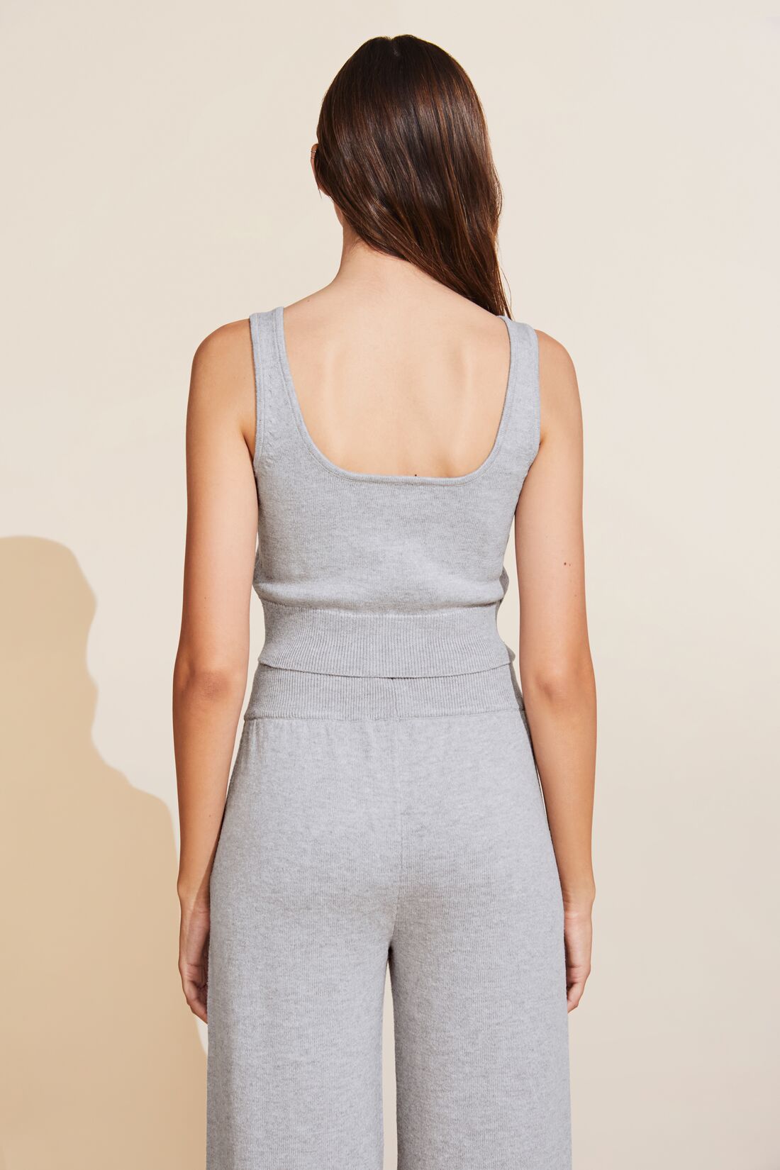 Model is wearing the Recycled Sweater Cropped Tank in Heather Grey.