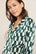 Model wears Inez Washable Silk Printed Long PJ Set in Mosaic Tile Forest Green/Navy. 