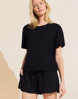 Model wears Organic Linen Knit Short Sleeve T-Shirt in Black.