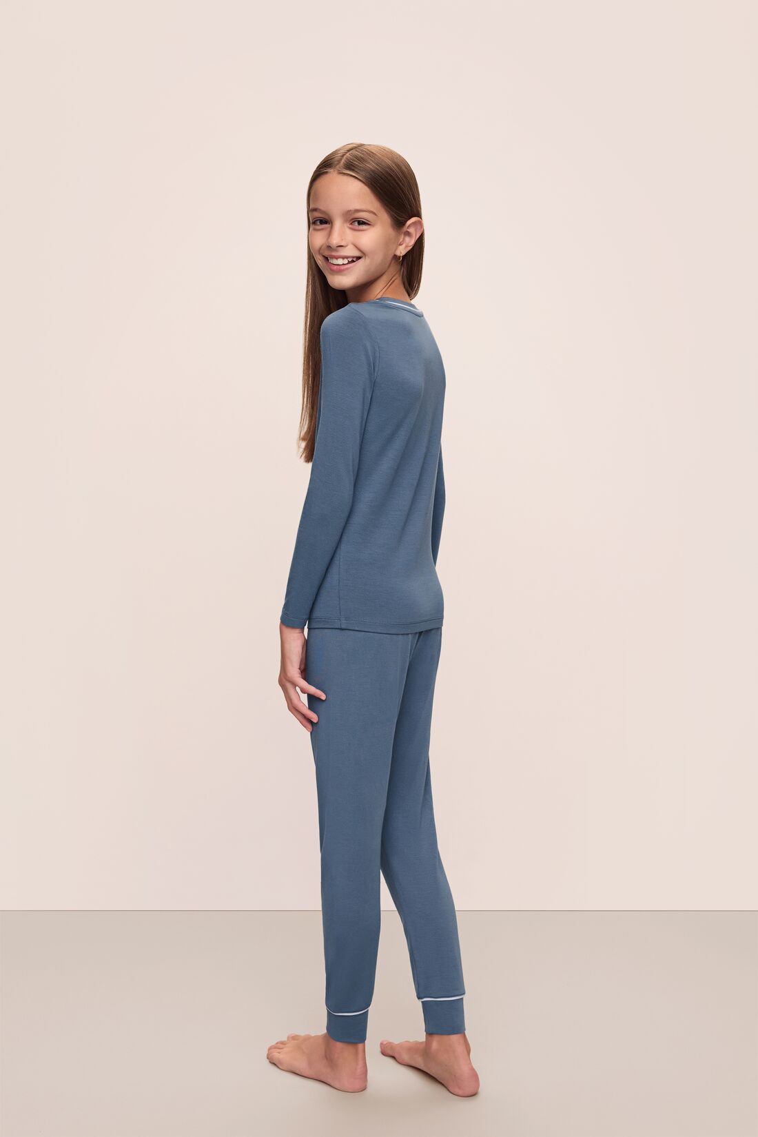 Model wears Kids TENCEL™ Modal Unisex Long PJ Set in Coastal Blue/Ice Blue.