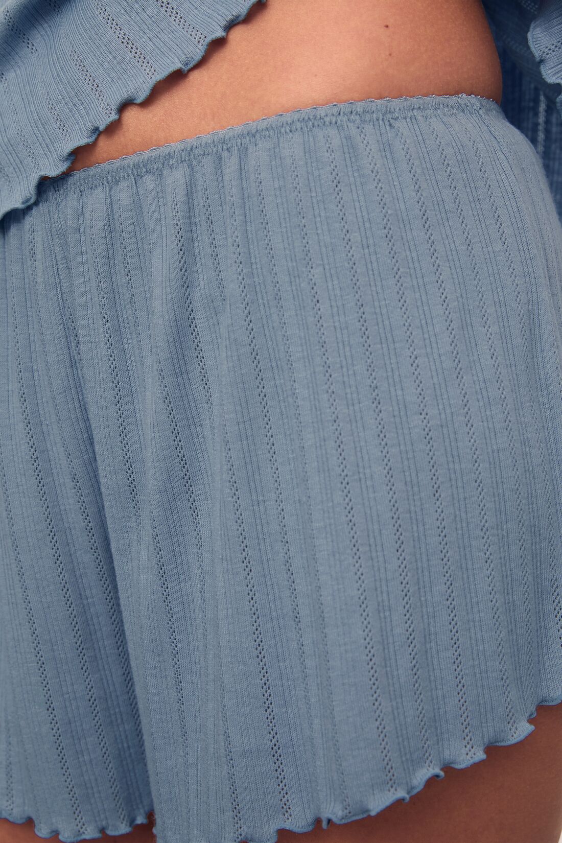 Model is wearing Pointelle Short in Faded Denim