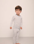 Model wears Kids Printed TENCEL™ Modal Unisex Long PJ Set in Petite Batik Ivory/Denim Blue.