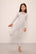 Model wears Kids Printed TENCEL™ Modal Unisex Long PJ Set in Petite Batik Ivory/Denim Blue.