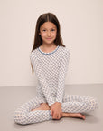 Model wears Kids Printed TENCEL™ Modal Unisex Long PJ Set in Petite Batik Ivory/Denim Blue.