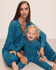Model is wearing Kids Printed TENCEL™ Modal Unisex Long PJ Set in Festive Lights Sapphire/Ivory.