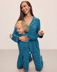 Model is wearing Kids Printed TENCEL™ Modal Unisex Long PJ Set in Festive Lights Sapphire/Ivory.
