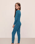 Model is wearing Kids Printed TENCEL™ Modal Unisex Long PJ Set in Festive Lights Sapphire/Ivory.
