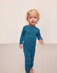 Model is wearing Kids Printed TENCEL™ Modal Unisex Long PJ Set in Festive Lights Sapphire/Ivory.