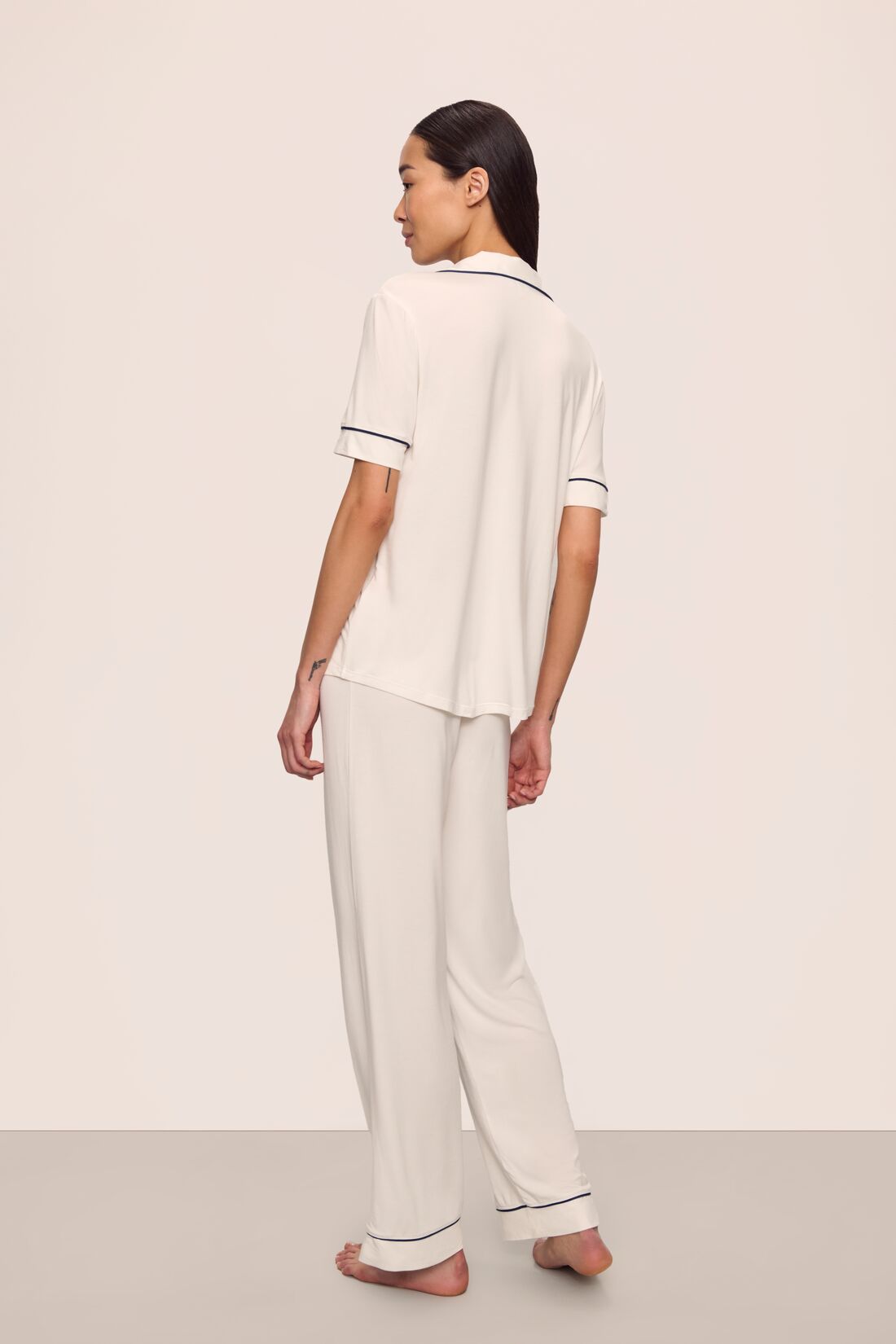 Model is wearing Gisele TENCEL™ Modal Short Sleeve & Pant PJ Set in Pure Ivory/Navy