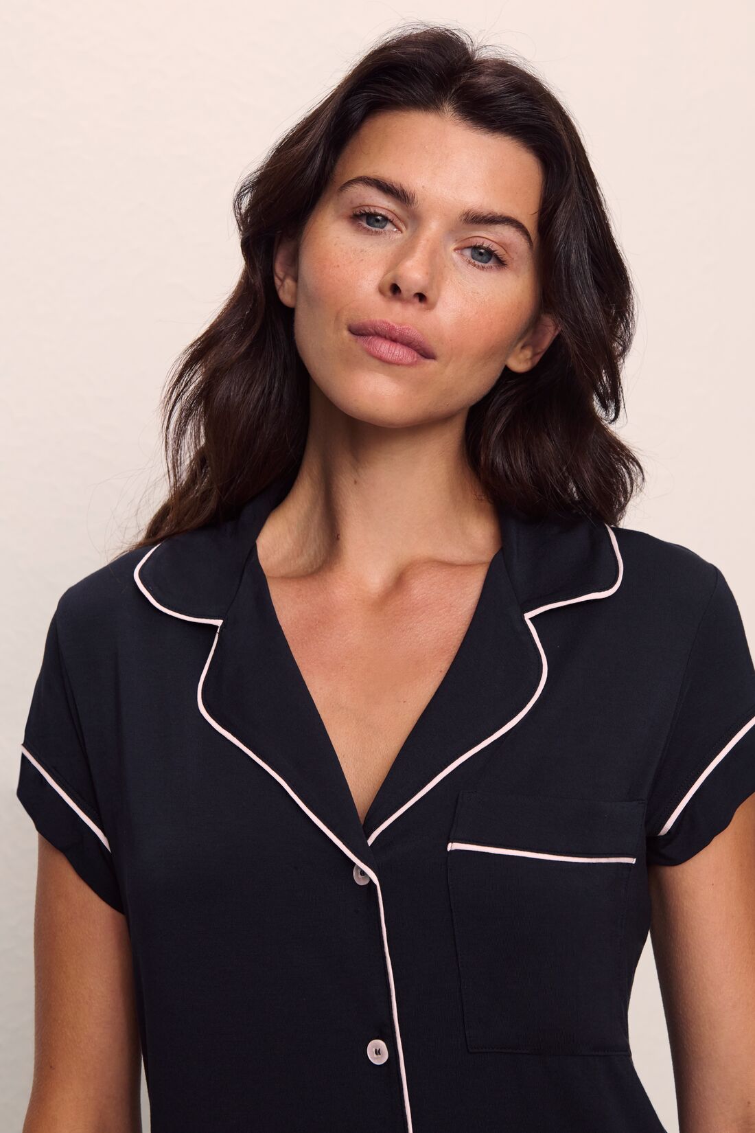 Model is wearing Gisele TENCEL™ Modal Short Sleeve Cropped PJ Set in Black/Sorbet Pink