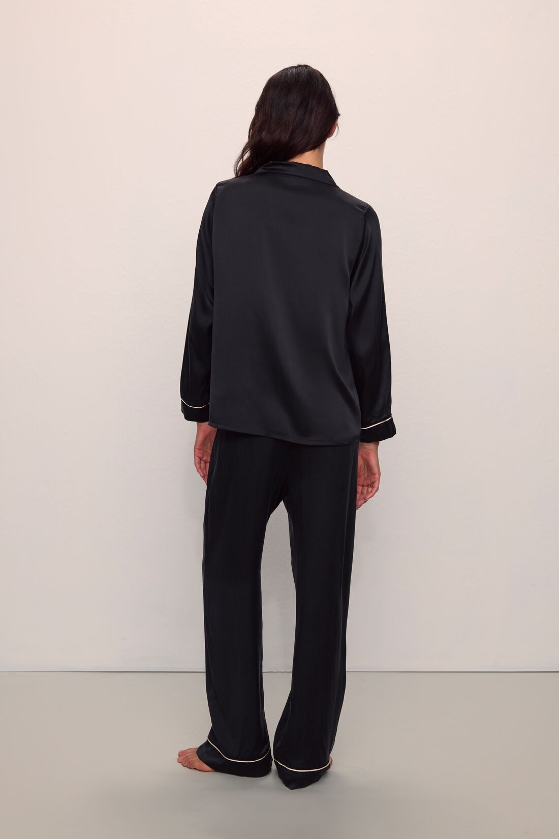 Model is wearing Inez Washable Silk Long PJ Set in Black/Champagne