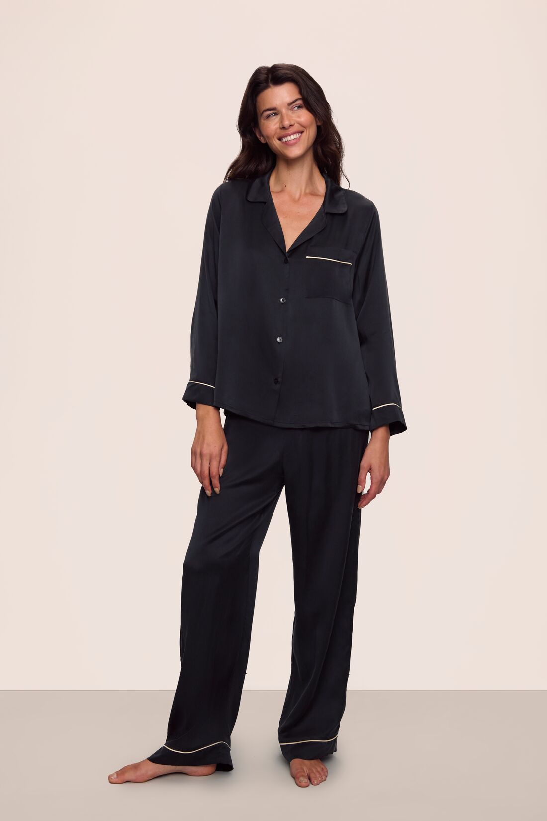 Model is wearing Inez Washable Silk Long PJ Set in Black/Champagne