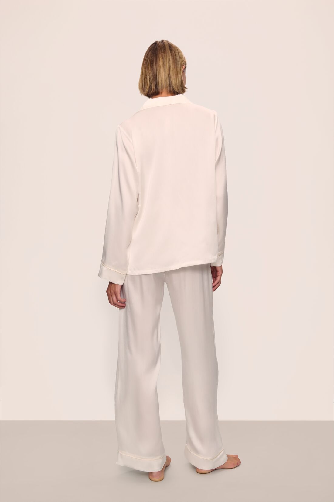 Model is wearing Inez Washable Silk Long PJ Set in Ivory/Champagne