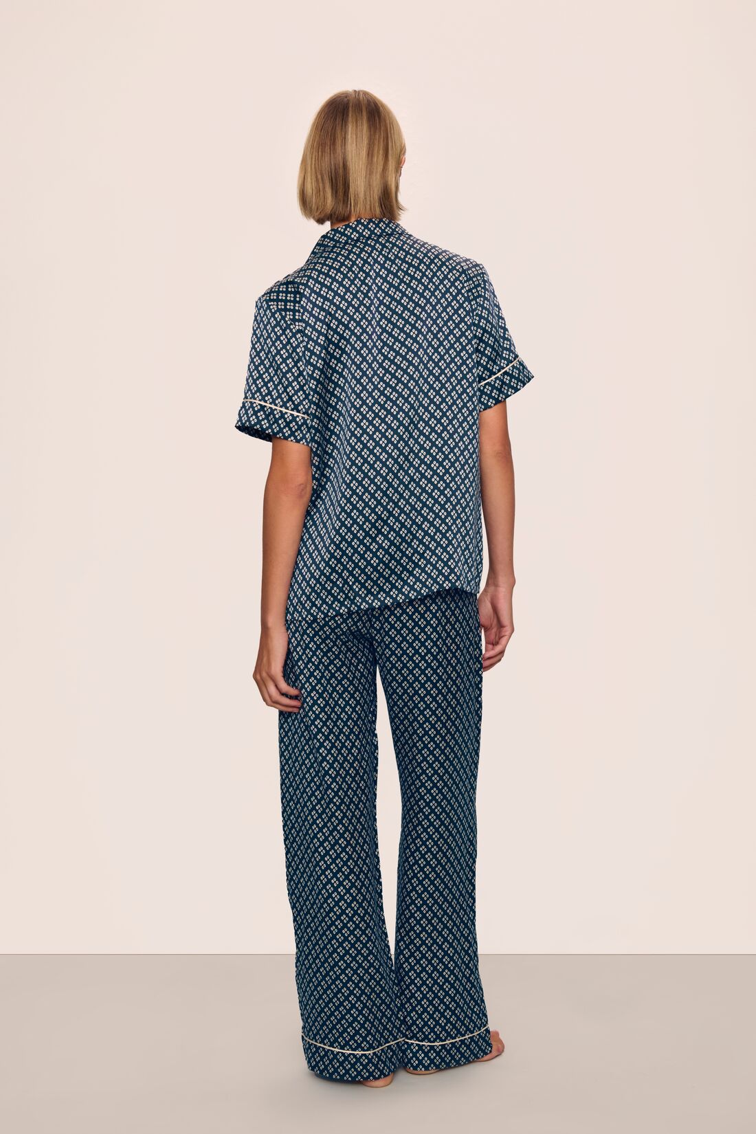 Model is wearing Inez Washable Silk Printed Short Sleeve Pant PJ Set in Petite Batik Navy/Ivory