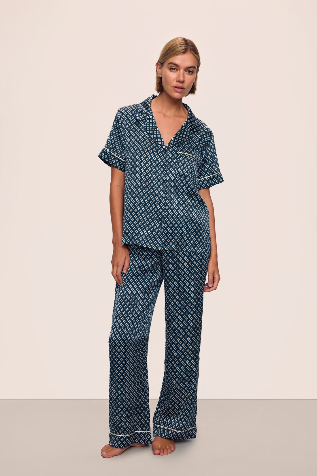 Model is wearing Inez Washable Silk Printed Short Sleeve Pant PJ Set in Petite Batik Navy/Ivory