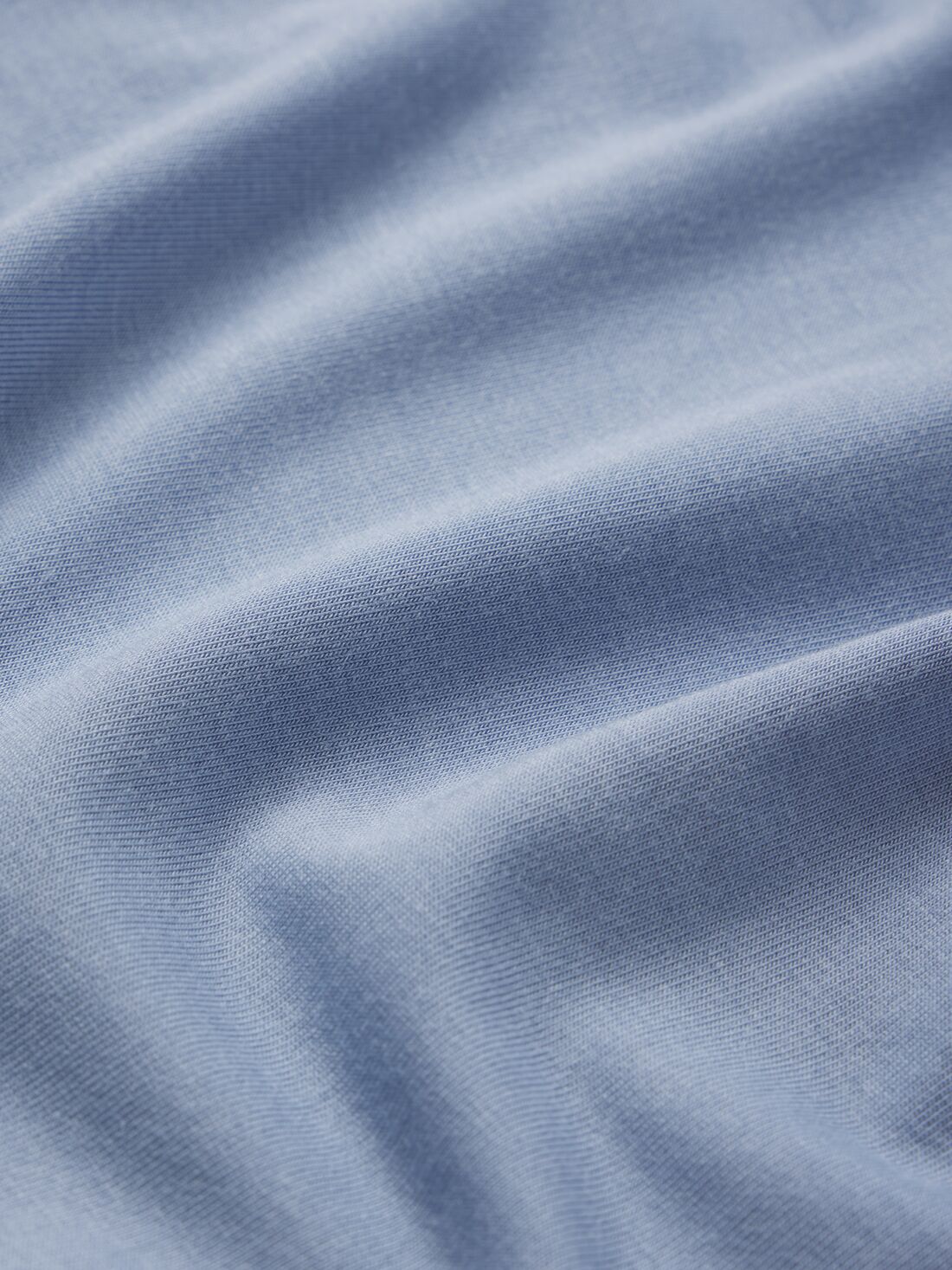 Model wears Kids TENCEL™ Modal Unisex Long PJ Set in Wedgewood Blue/Ivory.