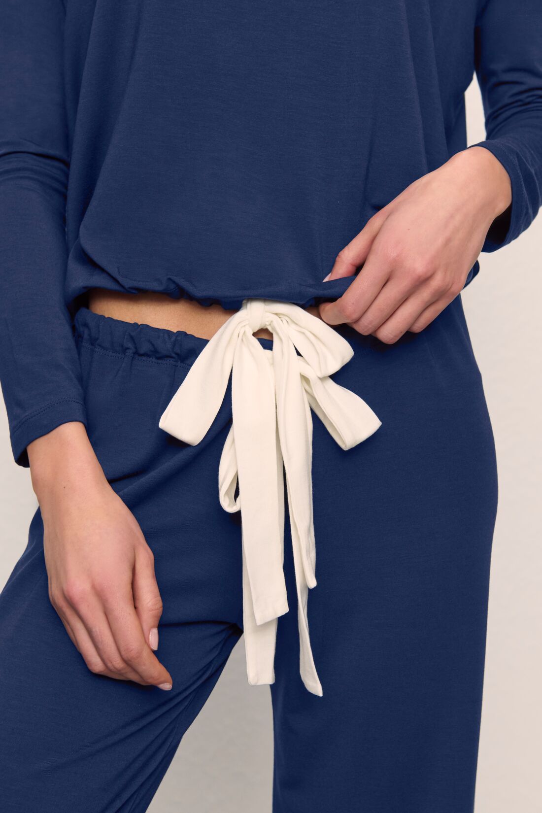 Model is wearing Gisele TENCEL™ Modal Slouchy PJ Set in Navy/Ivory