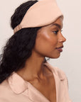 Model is wearing Washable Silk Eye Mask in Rose Cloud