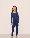 Model is wearing Kids TENCEL™ Modal Unisex Long PJ Set in Navy/Ivory