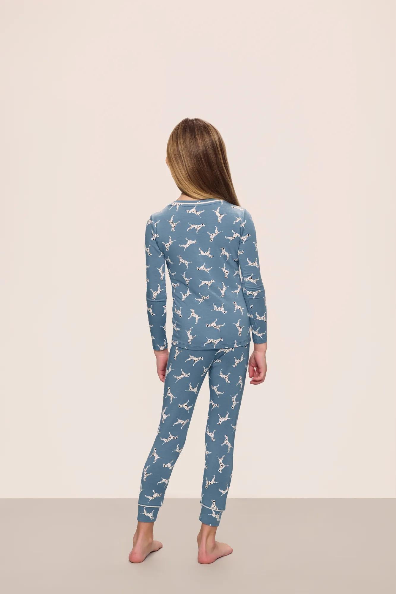 Model is wearing Kids Printed TENCEL™ Modal Unisex Long PJ Set in  Dalmatian Faded Denim/Ivory