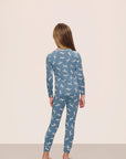Model is wearing Kids Printed TENCEL™ Modal Unisex Long PJ Set in Dalmatian Faded Denim/Ivory