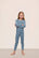 Model is wearing Kids Printed TENCEL™ Modal Unisex Long PJ Set in  Dalmatian Faded Denim/Ivory