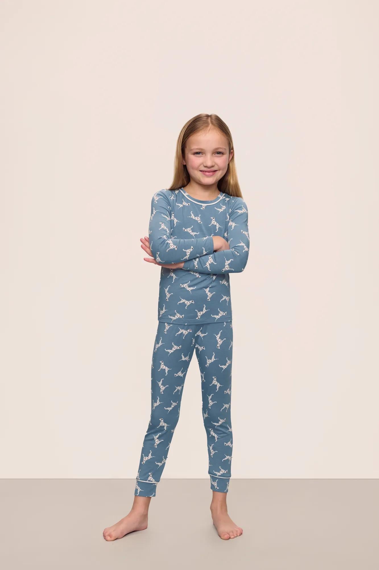 Model is wearing Kids Printed TENCEL™ Modal Unisex Long PJ Set in  Dalmatian Faded Denim/Ivory