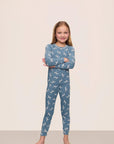 Model is wearing Kids Printed TENCEL™ Modal Unisex Long PJ Set in Dalmatian Faded Denim/Ivory