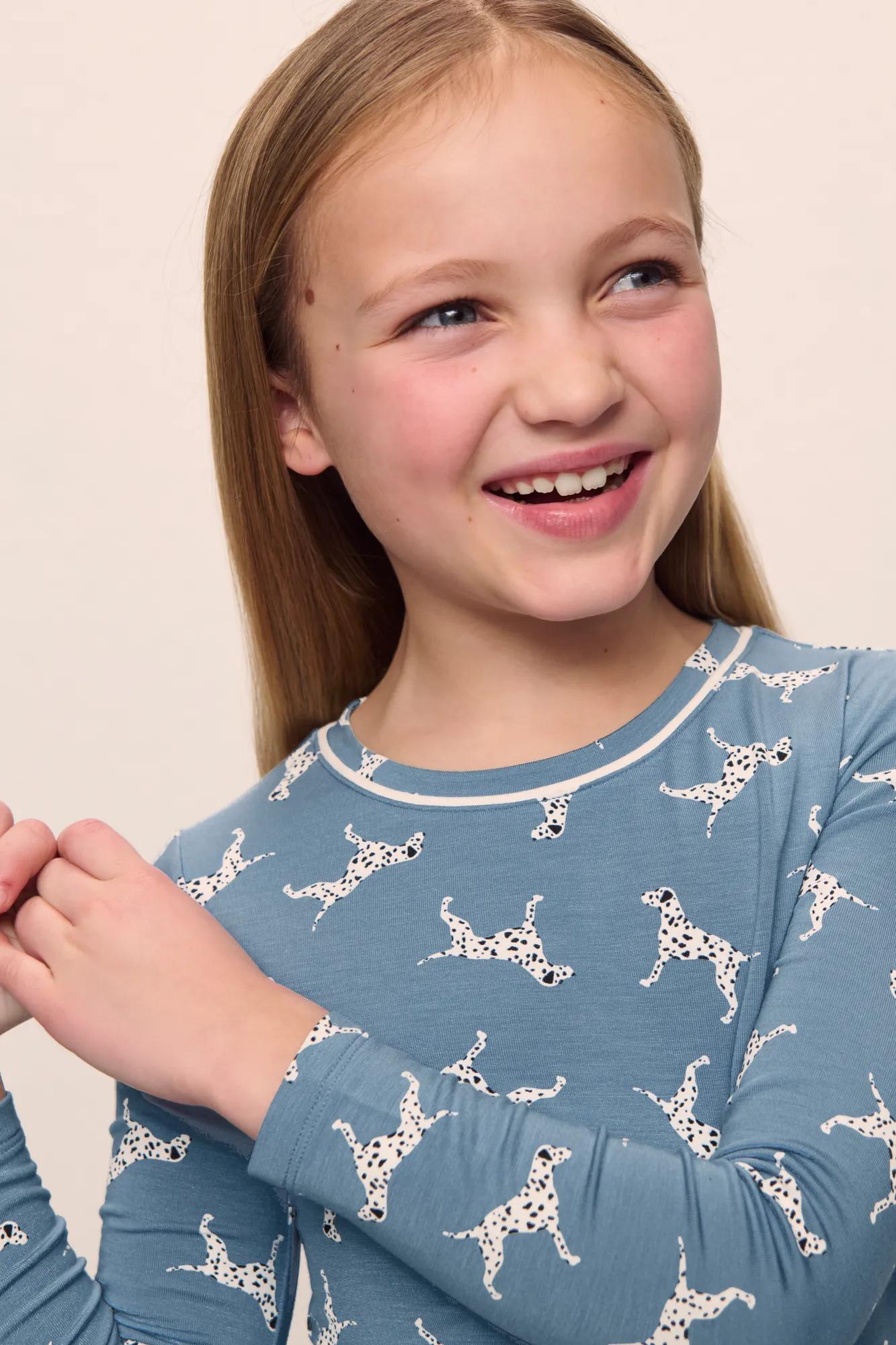 Model is wearing Kids Printed TENCEL™ Modal Unisex Long PJ Set in  Dalmatian Faded Denim/Ivory
