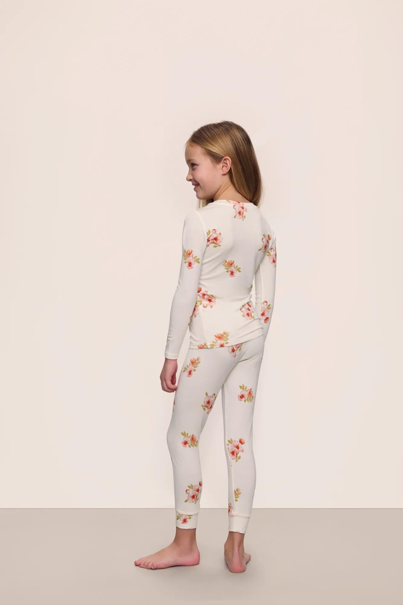 Model is wearing Kids Printed TENCEL™ Modal Unisex Long PJ Set in  Floral Bloom Ivy/Vanilla Cream