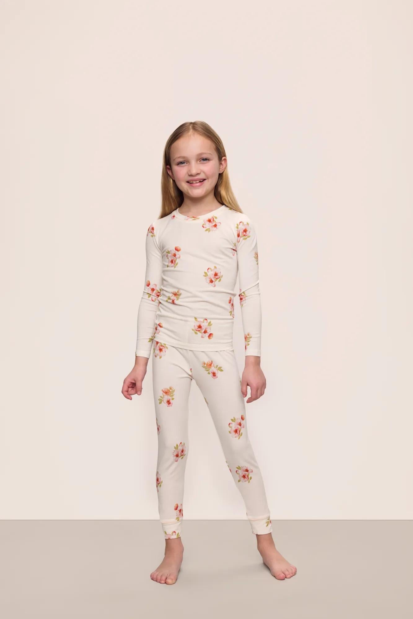 Model is wearing Kids Printed TENCEL™ Modal Unisex Long PJ Set in  Floral Bloom Ivy/Vanilla Cream