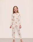 Model is wearing Kids Printed TENCEL™ Modal Unisex Long PJ Set in Floral Bloom Ivy/Vanilla Cream