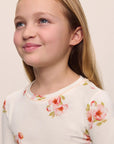 Model is wearing Kids Printed TENCEL™ Modal Unisex Long PJ Set in Floral Bloom Ivy/Vanilla Cream