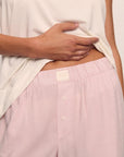 Model is wearing Nautico Boxer Pant in Feeder Stripespale Mauve/White